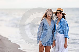 Beautiful mother and daughter at Carribean beach enjoying summer vacation