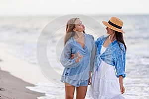 Beautiful mother and daughter at Carribean beach enjoying summer vacation