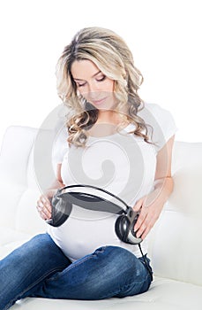 Beautiful mother giving her baby to listen to the music