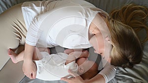 Beautiful mother and her cute little baby are sleeping at home,hugging in bed. Child safety and protection, co-sleeping