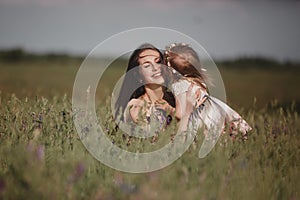 Beautiful Mother And her little daughter outdoors. Nature. Outdoor Portrait of happy family. Happy Mother`s Day Joy