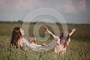 Beautiful Mother And her little daughter outdoors. Nature. Outdoor Portrait of happy family. Happy Mother`s Day Joy