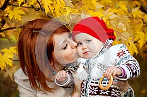 Beautiful mother hugging and kissing his little daughter