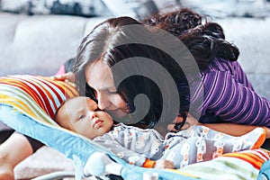 beautiful mother with newborn cute baby at home
