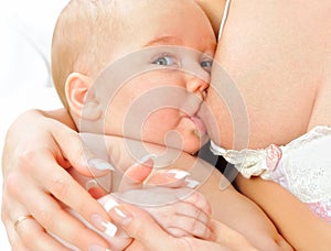 Beautiful mother nursing her newborn baby