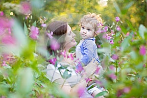 Beautiful mother playing with her one year old daughter on