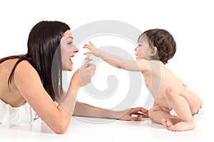 Beautiful mother playing with a pacifier with her baby