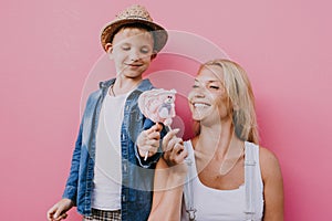 Beautiful mother and son on colored backgrounds