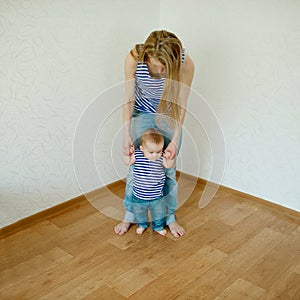 Beautiful mother teaches baby to walk