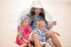 Beautiful mother and two kids enjoying beach vacation.