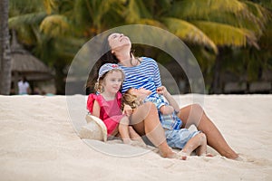 Beautiful mother and two kids enjoying beach vacation.