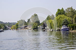 Beautiful motor cruisers and barges berthedon the Thames at Henley-on-Thames in Oxfordshire