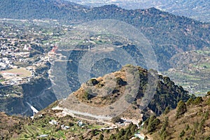 A beautiful mountain drone shot with low valleys and city scape. Tourism concept