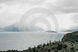 Beautiful mountain lake on a cloudy day. Landscape of a large lake in Queenstown, New Zealand.