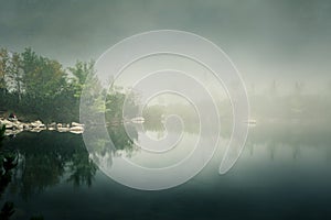 A beautiful mountain lake in a fog in Tatry, Slovakia.