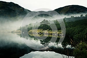 A beautiful mountain lake in a fog in Tatry, Slovakia.