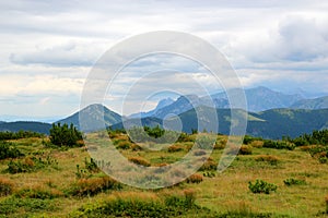 Beautiful mountain landscape with fog in the dark sky in front of the storm