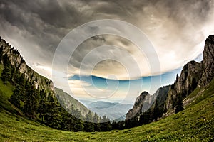 Beautiful mountain landscape with green trees and white clouds