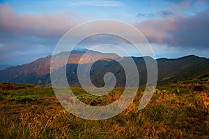 Beautiful mountain landscape, with mountain peaks covered with forest and a cloudy sky