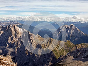 Beautiful mountain landscape with rocky mountains and blue sky. Hiking routes. There are white clouds on the horizon