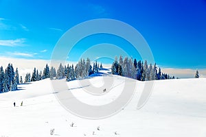 Beautiful mountain landscape and snowy paths in the snow with tourists.