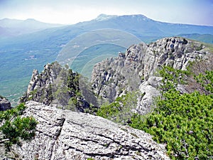 Beautiful mountain landscape with winded rocks. Distant mountain plateaus in a blue haze. Crimean mountains