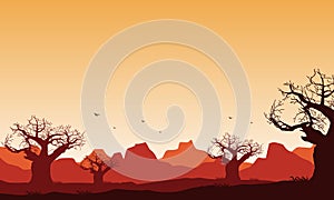 Beautiful mountain panorama in the desert with silhouettes of dry trees around it at twilight. Vector illustration