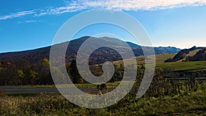 Beautiful mountain panorama from the road, green hills and blue sky