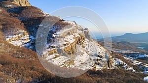 Beautiful mountain panorama with rock ledges and snow. Shot. Rock with small amount of snow on background of mountain