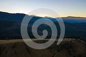 Beautiful mountain panoramic landscape with hazy peaks and foggy valley at sunset