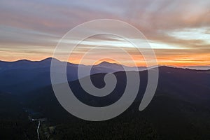 Beautiful mountain panoramic landscape with hazy peaks and foggy valley at sunset