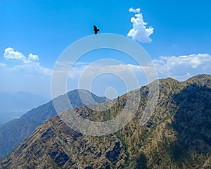 Beautiful mountain range with birds flying over the top in bright sunny day in Katra, Jammu Kashmir, Vaishno Devi