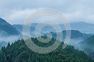 Beautiful mountain range covered with fog and rain in Yufuin, Oita, Japan