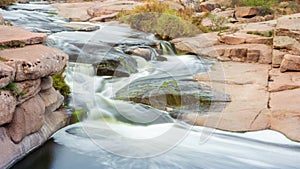 Beautiful mountain river flowing over rocks. Flow of water in mountain river close up