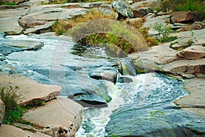 Beautiful mountain river flowing over rocks. Flow of water in mountain river close up