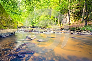 Beautiful mountain river stream. Sunny nature background of river and rocks