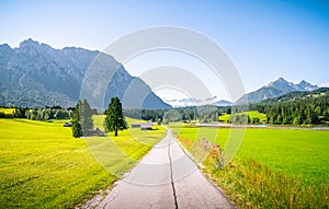 Beautiful mountain road in Mittenwald Germany alps. Panorama view field and meadow.