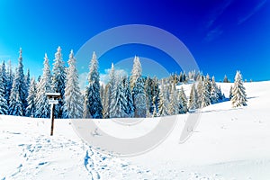 Beautiful mountain snowy landscape and turistic destination sign.