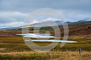 Beautiful mountain view during auto trip in Iceland. Spectacular Icelandic landscape with  scenic nature: mountains, fields,