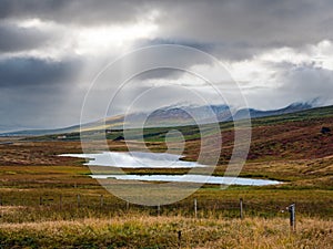 Beautiful mountain view during auto trip in Iceland. Spectacular Icelandic landscape with  scenic nature: mountains, fields,