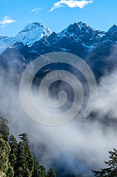 A beautiful mountain view with fog and clouds