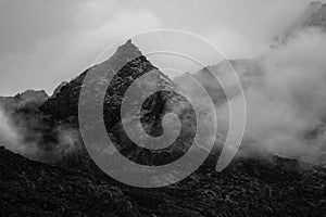 A beautiful mountain view with fog and clouds