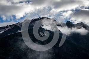 A beautiful mountain view with fog and clouds