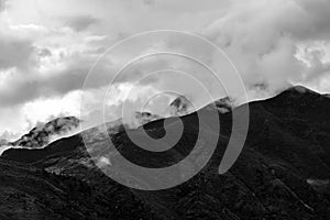 A beautiful mountain view with fog and clouds