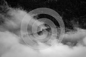 A beautiful mountain view with fog and clouds