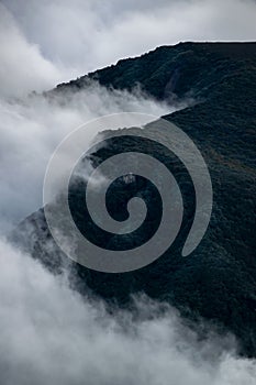 A beautiful mountain view with fog and clouds