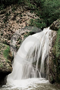 Beautiful mountain waterfall captured with motion blur