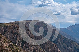 Beautiful mountains with plateau ending with rocky cliff. Mountain valley landscape. Travel concept. Kora river mountain gorge.