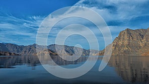 Beautiful mountains reflected in the water. Fjords on the Musandam peninsula. Khasab. Oman