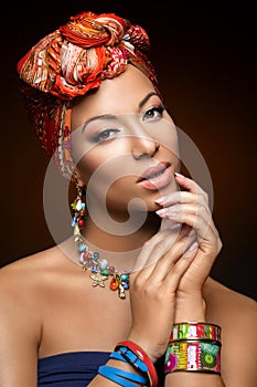 Beautiful mulatto young woman with turban on head